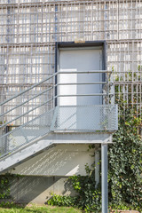 steel door with an iron staircase. the entrance to the industrial premises