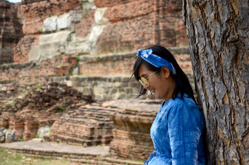 Thai women portrait with tree at ancient building