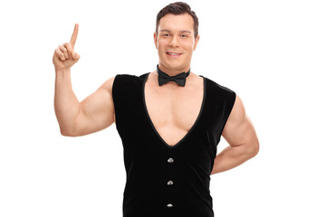 Fototapeta premium Sexy young guy in a black vest and bow-tie