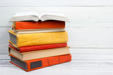 Open book, hardback books on wooden table. Back to school. Copy space