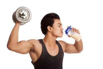 Fototapeta na wymiar Muscular Asian man with dumbbell and whey protein shakes