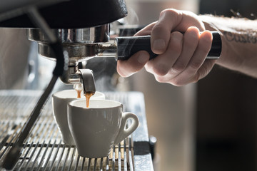 coffee making process; espresso cup and coffee machine;