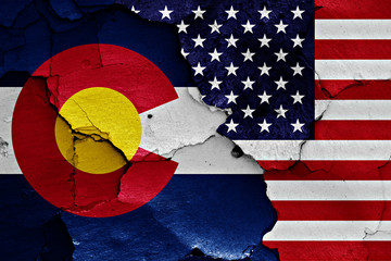 flags of Colorado and USA painted on cracked wall