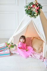 Little girl in pink dress near wigwam © avikki