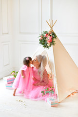 Mother and baby girl near wigwam © avikki
