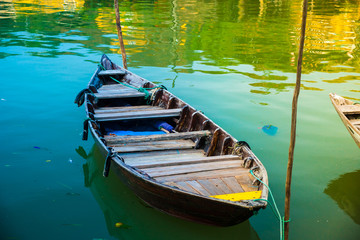Fototapeta premium Traditional boats in front of ancient architecture in Hoi An, Vietnam. Hoi An is the World's Cultural heritage site, famous for mixed cultures & architecture.