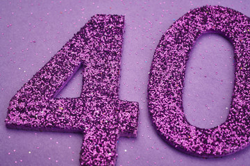 Number forty purple color over a purple background. Anniversary
