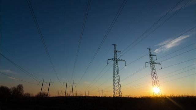 Time Lapse Electric high voltage pylon. Sunset sky. Beautiful landscape