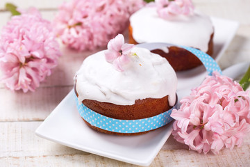 Easter cake, pink hyacinth, willow branches on white wooden back