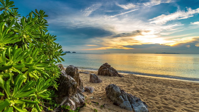 4K TimeLapse. Sunset on the rocky beach overgrown with plants, Koh Samui, Thailand