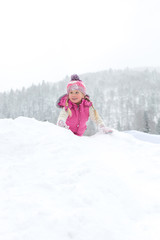little girl happily playing in the snow