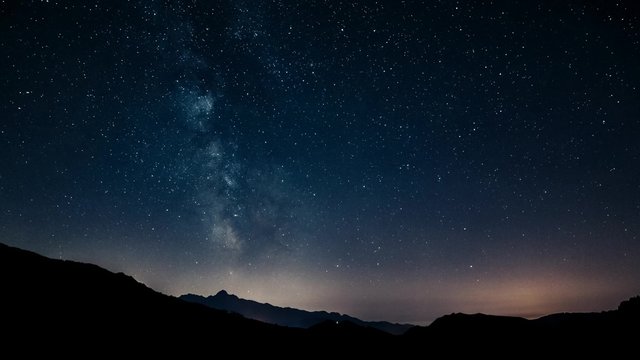 timelapse night sky stars milky way on mountains background. 4K. Tuscany 