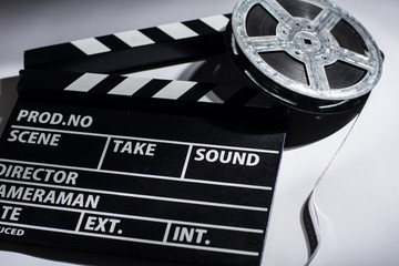 Close-up of cinema clap and film reel with