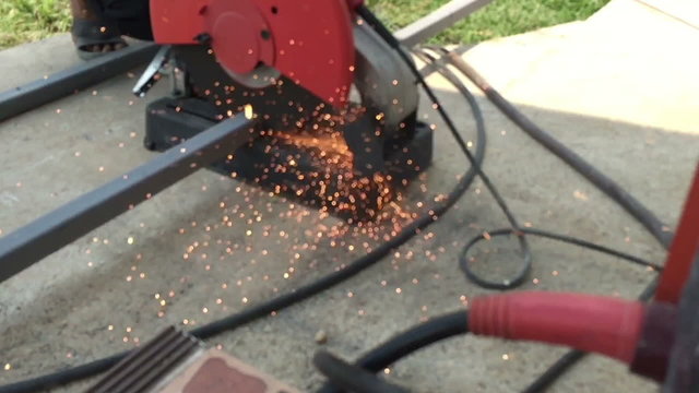 Slow motion cutting metal steel rod in two pieces with angle grinder