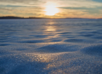 Blurred sunset at a lake in the winter. Very shallow depth of field used to create the ethereal athmosphere. 