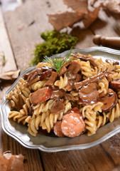 Obraz na płótnie Canvas Fussili pasta with mushrooms and sausage