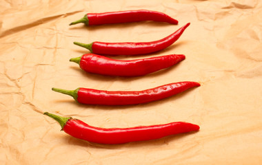 Red hot chili peppers on old paper sheet