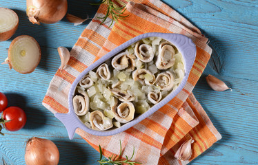 Marinated herring rools with oil and onion