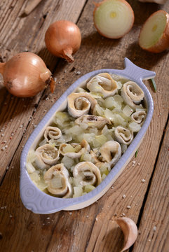 Marinated herring rools with oil and onion