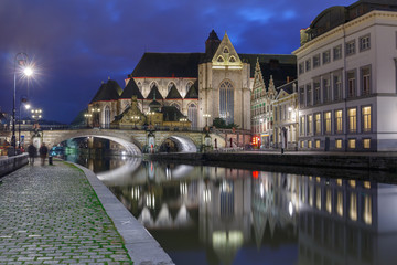 Fototapeta na wymiar Quay Graslei, picturesque medieval St Michael's Bridge and church at night in Ghent, Belgium