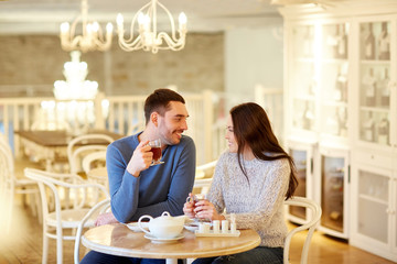 happy couple drinking tea at cafe