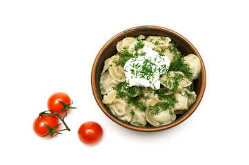 Russian dumplings with sour cream and cherry tomatoes.