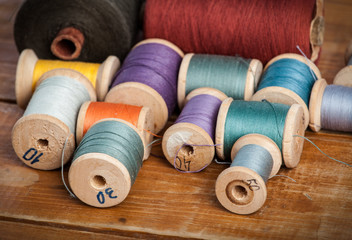 Sewing on the background of the old wooden walls