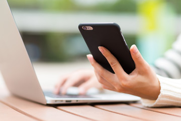 Woman use of cellphone and laptop computer