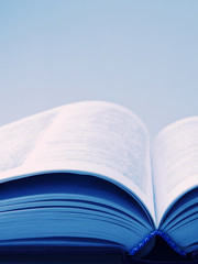 Open book with blurred pages (in blue tones, retro style) with copy space for your text