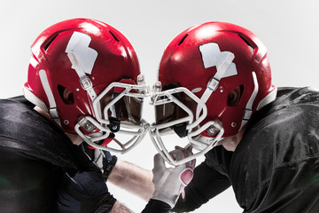 The two american football players fighting on white background