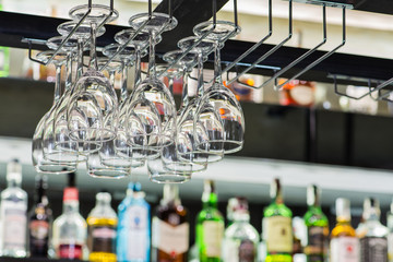 Empty glasses for wine above a bar rack, Hanging to Dry