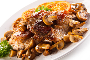 Grilled beefsteaks and vegetables