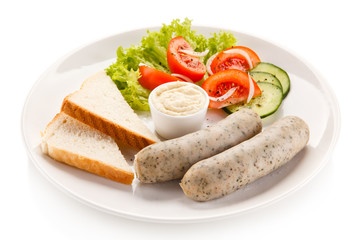 Fototapeta na wymiar Easter breakfast - eggs, boiled white sausages and vegetables