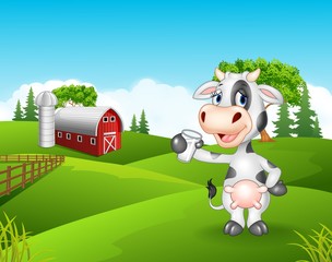 Cartoon cow holding glass in the farm 