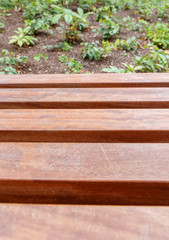 Empty wooden bench with blurry natural  background