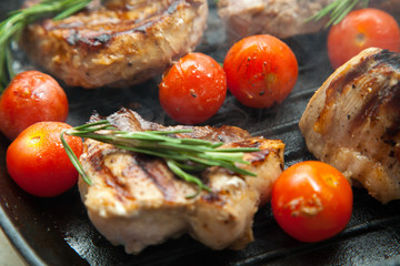 Grilled bbq steaks with fresh herbs and tomatoes