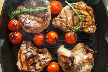 Grilled bbq steaks with fresh herbs and tomatoes