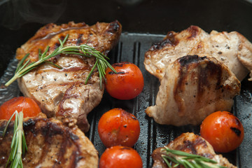 Grilled bbq steaks with fresh herbs and tomatoes