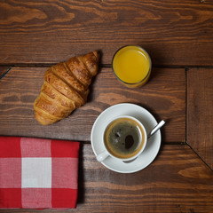 Shot Of Coffee And Croissant On Table