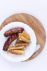Fried homemade sausages with french fries