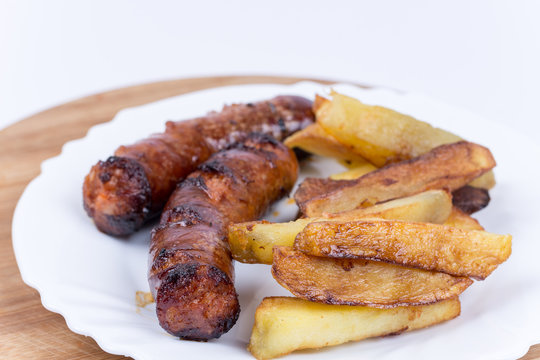 Fried homemade sausages with french fries