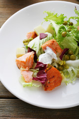 slice of roasted salmon and salad