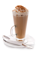 Glass cup of hot coffee with cream and cinnamon