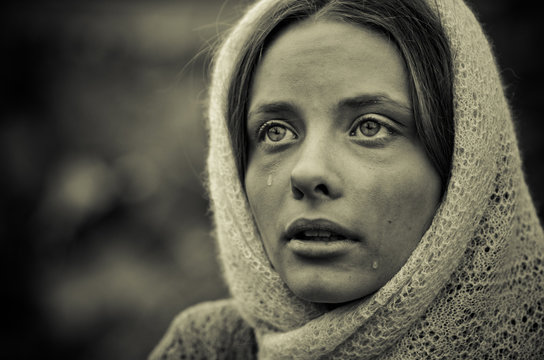 Young Girl Dressed In The Poor Sweater And Scarf