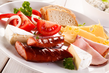 Breakfast - fried sausages, yello cheese and vegetables