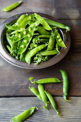 fresh green peas on rustic boards