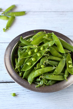 fresh green peas on boards