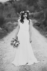 black and white portrait of bohemian bride in nature, with bouqu