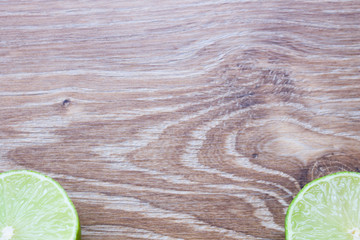 Lime slices on wooden background 