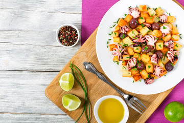Potato salad with pickled octopus, top view